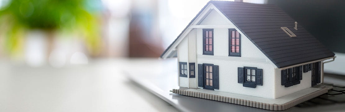 A model house on a laptop.